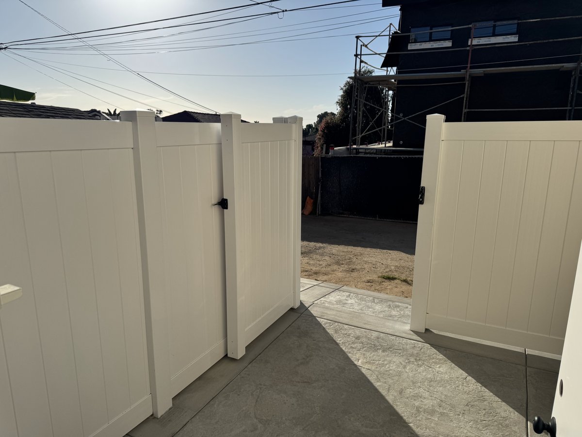 New white vinyl privacy fence and gate installed for ADU exterior access