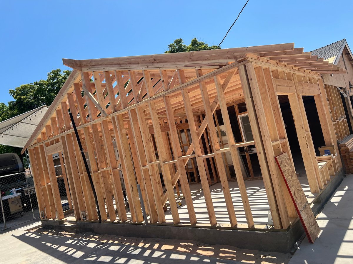 New ADU addition framing under construction with roofline and wall layout visible