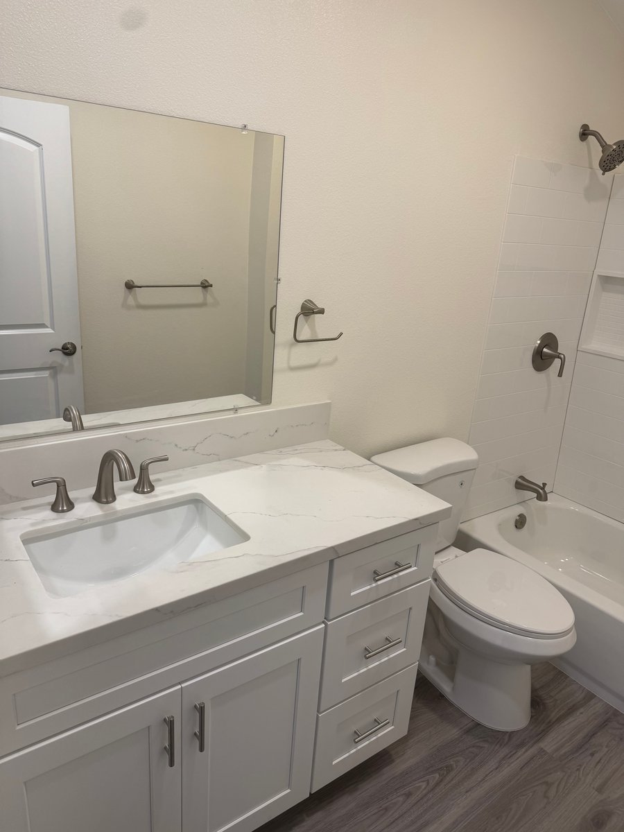 Modern ADU bathroom vanity with quartz countertop, undermount sink, and brushed nickel faucet