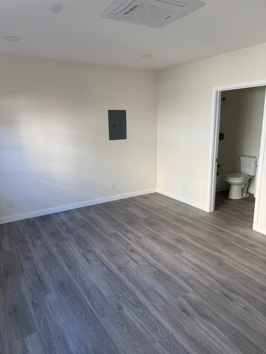 Finished ADU bedroom with vinyl plank flooring