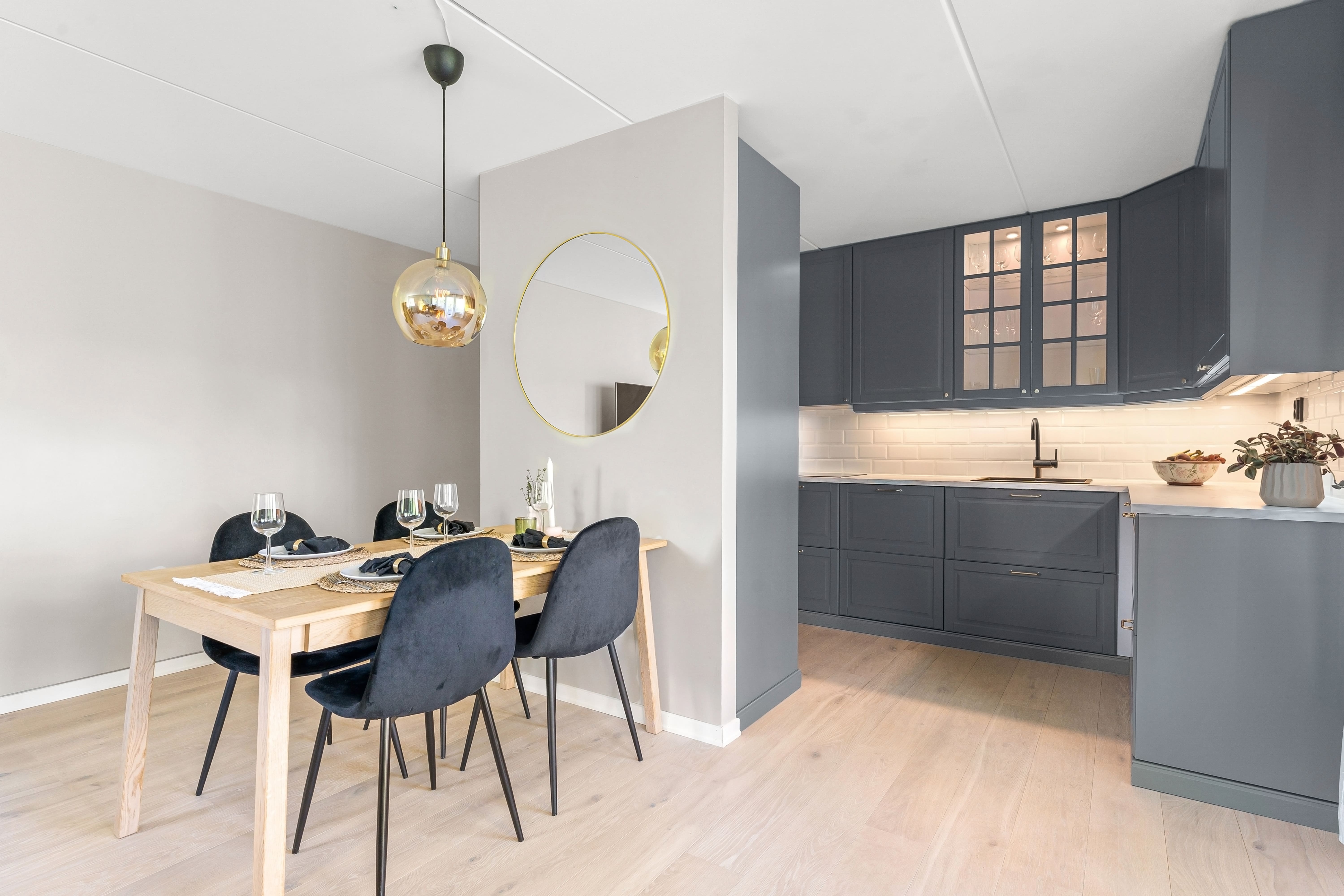 Accessory Dwelling Unit ADU Kitchen featuring Velvet MCM Chairs and Beautiful Grey Hidden Handle Cabinetry